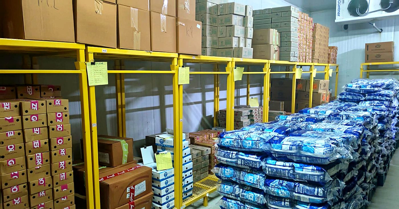 Palletised ice cube bags and frozen cartons in the Coimbatore cold storage facility